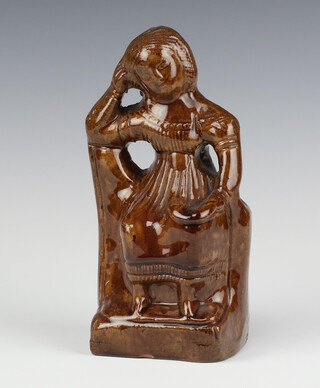 A 19th Century  brown glazed money bank in the form of a seated lady 20cm 