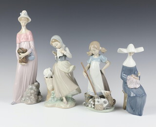 A Lladro figure of a girl with kittens 5239 21cm, ditto of a seated nun 5501 20cm, a girl with doves 23cm and a lady with puppy 30cm 