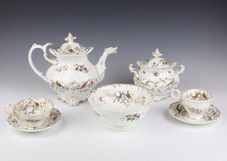 A Victorian Coalbrookdale style tea set comprising teapot and lid, sucrier and lid (chipped), 12 large tea cups, 10 large saucers, 3 small tea cups, 3 plates and a bowl, decorated with exotic birds 