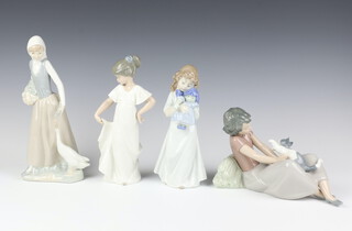 A Nao figure of a goose girl 23cm, a girl with doll 20cm, a standing girl 21cm and a girl with kitten 15cm 