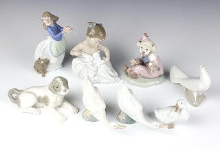 A Nao figure of a resting hound 8cm, a ditto clown 14cm, a baby 15cm, a girl with puppy 14cm,  3 geese 6cm and a dove 4cm