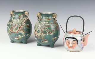 A 1920's Japanese porcelain teapot decorated with masks 7cm, a pair of ditto green ground baluster vases decorated with dragons 17cm 