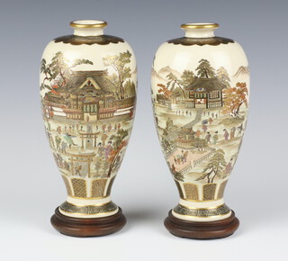 A pair of early 20th Century Japanese oviform vases decorated with processions of figures in extensive country landscapes with seal mark to base 18cm 