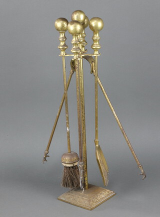 A gilt metal 4 piece fireside companion set comprising poker shovel brush and tongs 