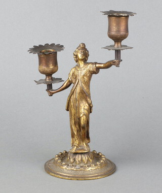 A 19th/20th Century gilt metal twin light candelabrum with detachable sconces, the support in the form of a standing lady on a circular base 21cm 
