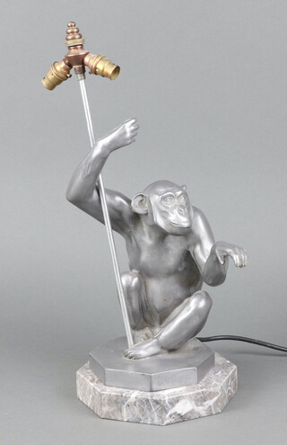 An Art Deco style resin table lamp in the form of a seated chimp, raised on an octagonal grained marble base 38cm x 18cm 