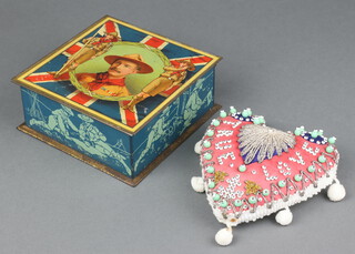 A CAW & Co Ltd biscuit tin, the lid decorated Baiden Powell and containing a heart shaped cushion decorated beads marked True Love 11cm x 12cm 