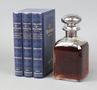 A 70cl decanter shaped bottle of Henessey Cognac contained in a presentation box in the form of books  