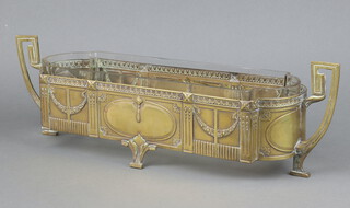 An Art Nouveau WMF style embossed gilt metal twin handled planter with glass liner 14cm h x 48cm w x 14cm d  