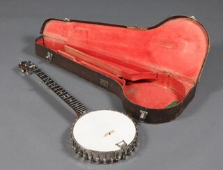 The Windsor Premier, a 4 stringed banjo with chrome body and rosewood neck compete with hard carrying case 