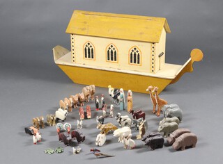 A 1920's wooden Noah's Ark and animals, created by the War Relief Toy Works, Stoke Newington, hand painted mustard hull and roof, cream deck and walls, with orange and black gothic arched windows, port side wall with painted War Relief Toy Work Company logo, the hinged roof revealing an interior, 50cm h x x 106cm l x 25cm, there are 64 hand painted carved wooden figures including Noah and his wife (Naamah)