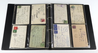 A brown ring bound album of postcards mainly of postmark and stamp interest 