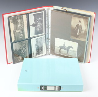 A ring bound album containing black and white postcards and photographs of huntsmen and hounds and a collection of paper race course badges and a turquoise album containing receipts and bills etc 