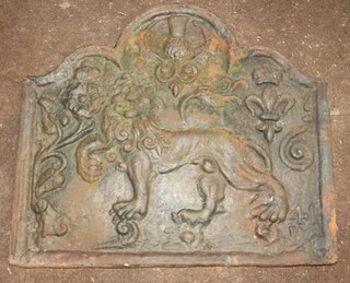 An arch shaped cast iron fire back decorated a walking lion 67cm  