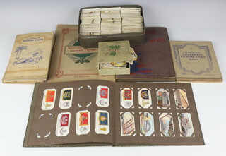 John Players cigarette card album - military uniforms British Empire and Overseas, album of Wills - Ocean Liners, Lambert and Butler - motorcycles, a metal tin containing various cigarette cards and 8 other albums of cards 