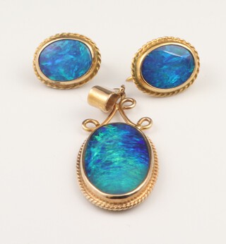 A yellow metal opal set pendant and a pair of ditto 9ct earrings 