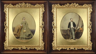 A pair of oval Victorian photographs of a lady and gentleman, over painted in fancy gilt frames 26cm x 20cm 