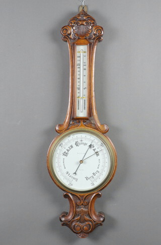 A 19th Century aneroid barometer and thermometer, the 20cm porcelain dial marked Botly and Lewis  contained in a carved oak wheel case 82cm h x 25cm 