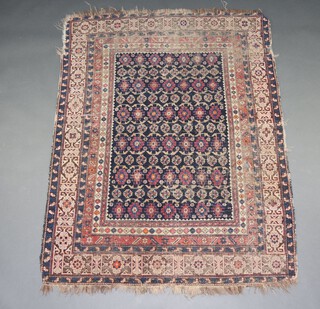 A blue, red and white ground Persian rug, decorated numerous medallions within a central medallion and multi row border 167cm x 126cm 