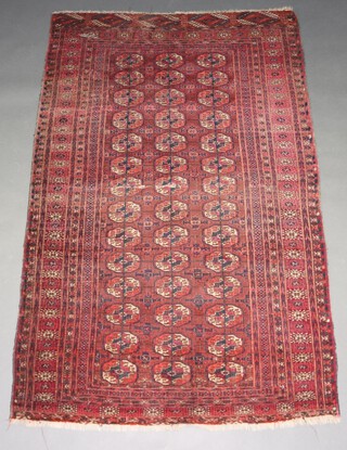 A red and blue ground Bokhara rug with 43 octagons to the centre within a multi row border 202cm x 128cm 