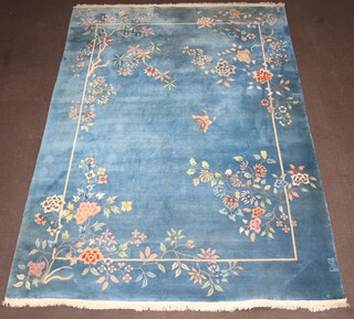 A 1930's blue and floral ground Chinese carpet decorated a butterfly 366cm x 274cm 