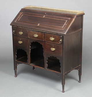An Edwardian mahogany bureau with brass 3/4 gallery the fall front revealing a fitted interior above 5 drawers and niches, raised on turned supports 88cm h x 91cm w x 42cm d 