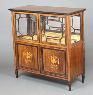 An Edwardian inlaid mahogany display cabinet with mirrored back and plush interior, enclosed by bevelled astragal panelled doors, the base enclosed by a pair of inlaid doors 89cm h x 96cm w x 40cm d 