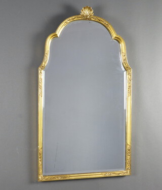 A 1950's Georgian style arch shaped bevelled plate mirror contained in a gilt frame surmounted by a shell 62cm x 46cm 