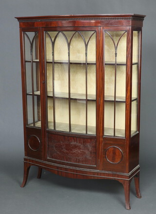 An Edwardian mahogany bow front display cabinet with moulded cornice, fitted shelves enclosed by astragal glazed panelled doors, on splayed bracket feet 176cm h x 124cm w x 41cm d 