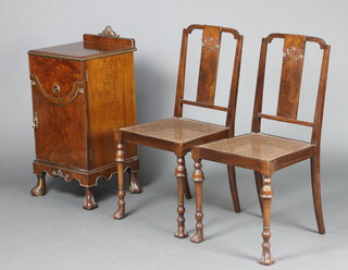 A 1930's Italian style walnut bedside cabinet with raised back carved a shell, the shelved interior enclosed by a panelled door, raised on scroll shaped supports 85cm h x 39cm w x 39cm d, together with a pair of slat back bedroom chairs with woven cane seat, cup and cover supports 89cm h x 43cm w x 44cm d 