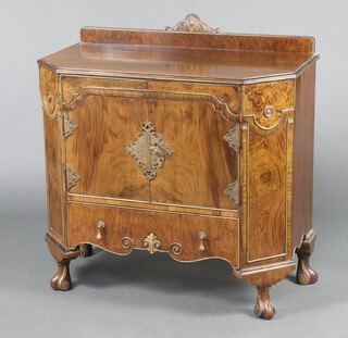 A 1930's Italian style walnut side cabinet/wash stand with raised back carved a shell, fitted a cupboard with shelf enclosed by panelled doors above 1 long drawer, raised on cabriole supports 95cm h x 92cm w x 48cm d 