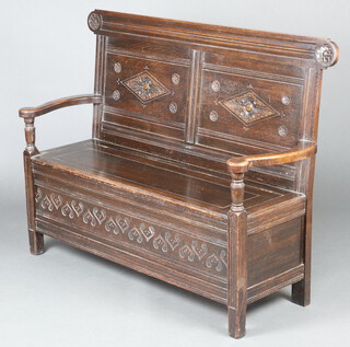 A Victorian carved oak settle with hinged lid raised on square supports 102cm h x 132cm w x 44cm d (seat 106cm x 31cm) 