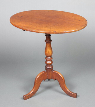 An oval mahogany snap top wine table raised on a pillar and tripod base 72cm h x 59cm w x 51cm d 