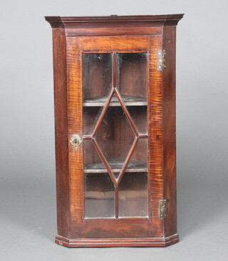 A 19th Century mahogany hanging corner cabinet with moulded cornice, fitted shelves enclosed by an astragal glazed panel door 87cm h x 51cm w x 36cm d 