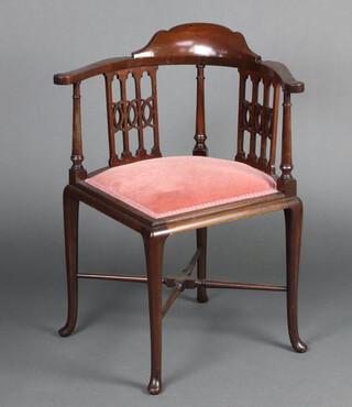 An Edwardian  mahogany corner chair with upholstered seat, raised on cabriole supports with X framed stretcher  75cm h x 60cm w x 58cm d (seat 29cm x 28cm) 