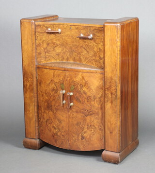 In the manner of Epstein, an Art Deco figured walnut cocktail cabinet with hinged lid and cupboard enclosed by panelled doors  114cm h x 92cm w x 42cm d -  PLEASE NOTE this cabinet is ensuite with the Art Deco dining table and chairs in lot 1071