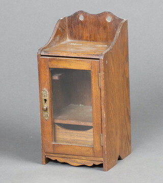 An Edwardian oak hanging smoker's cabinet with hinged lid, enclosed by a glazed panelled door 31cm h x 15cm w x 14cm d 