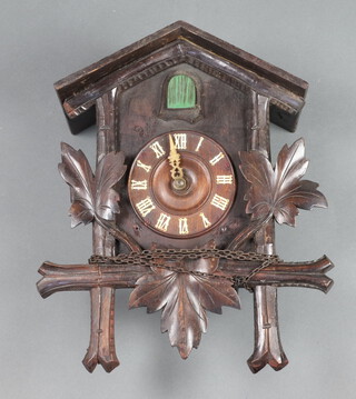A cuckoo clock contained in a carved case (requires restoration) 39cm h x 29cm w x 20cm d 