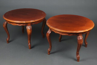 A pair of circular mahogany finished occasional tables with pie crust edge, raised on cabriole supports with plate glass tops 46cm h x 66cm diam. 