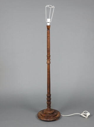 An Art Deco turned beech standard lamp on a circular stepped base 138cm h