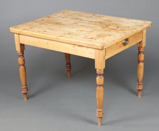 A Victorian style rectangular pine table fitted a drawer raised on turned supports 75cm h x 106cm w x 83cm d  (ring and contact marks in places)