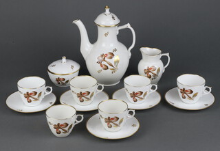 A Royal Copenhagen coffee set with gilt floral decoration comprising coffee pot and lid, milk jug, sugar bowl and cover, 5 cups, 5 saucers 