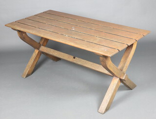 A rectangular slatted hardwood garden table on X framed supports with H framed stretcher 71cm h x 75cm w x 155cm 