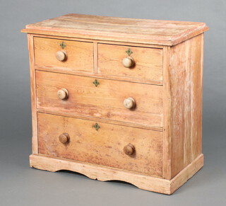 A pine chest of 2 short and 2 long drawers with tore handles, raised on a platform base 86cm h x 94cm w x 49cm d (ring mark and split to top) 