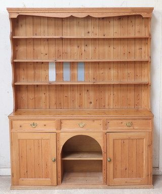 A Victorian style pine dog kennel dresser, the raised back with moulded cornice fitted shelves above 3 drawers, dog kennel to the middle flanked by cupboards (there are 3 striped panels of paint to the back) 214cm h x 169cm w x 43cm d 
