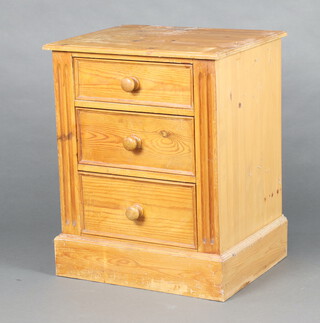 A pine pedestal chest of 3 drawers with turned handles on a platform base (some water marks)
