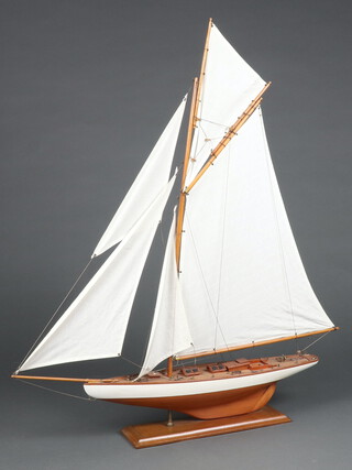 A wooden model of a J-Class yacht 94cm h x 74cm w x 12cm d 