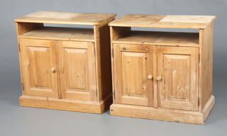 A pair of pine cabinets fitted recess above cupboard enclosed by a panelled door 77cm h x 76cm w x 45cm d (some water and contact marks in places)