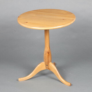 A circular pine wine table raised on pillar and tripod supports 57cm h x 50cm diam.