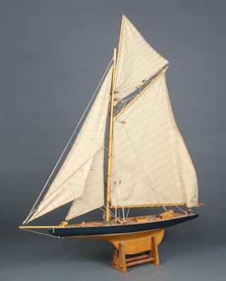 A wooden model of a J-Class yacht 97cm h x 79cm w x 13cm d 
